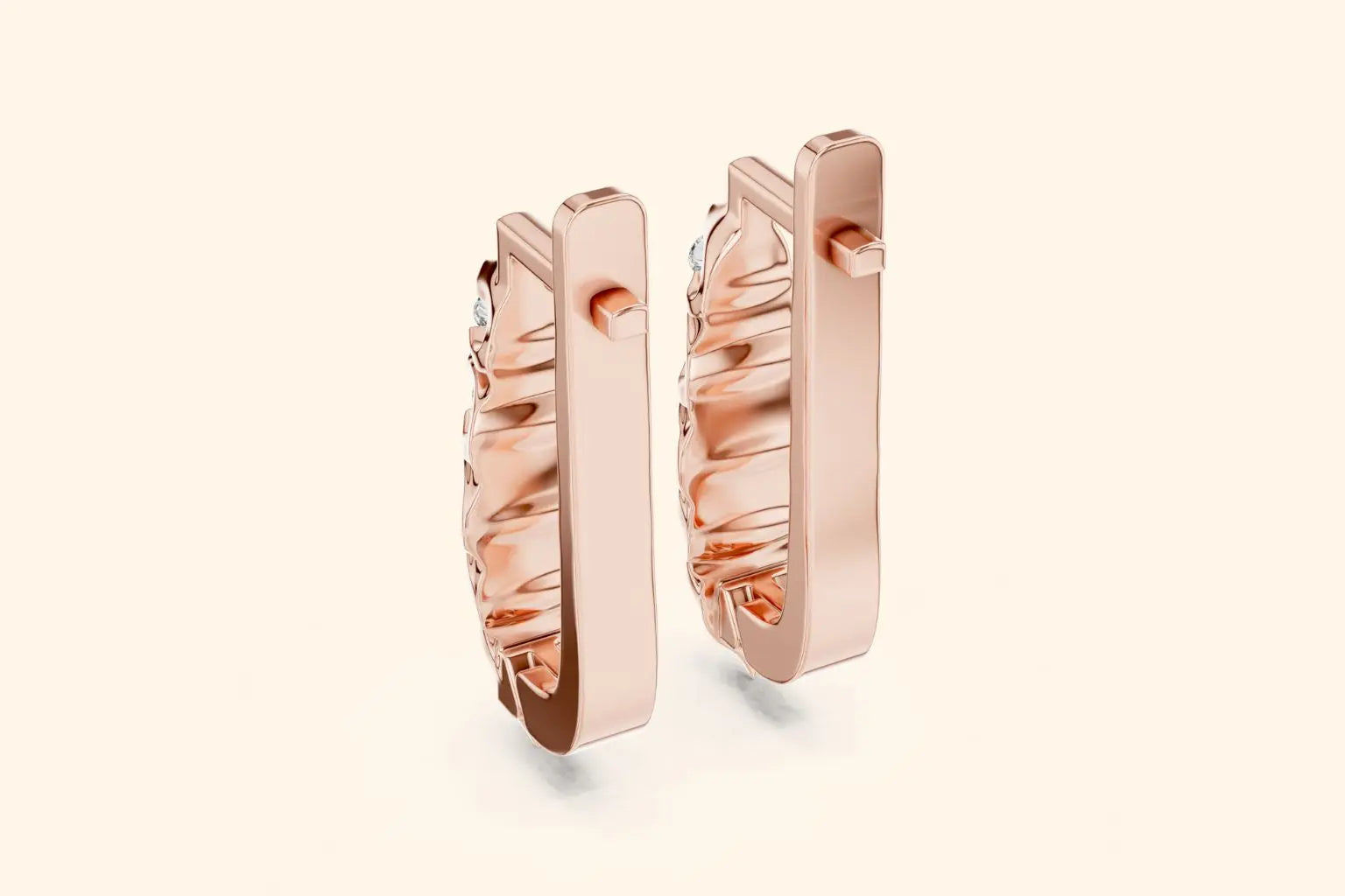 Rose gold hoop earrings on a light beige background