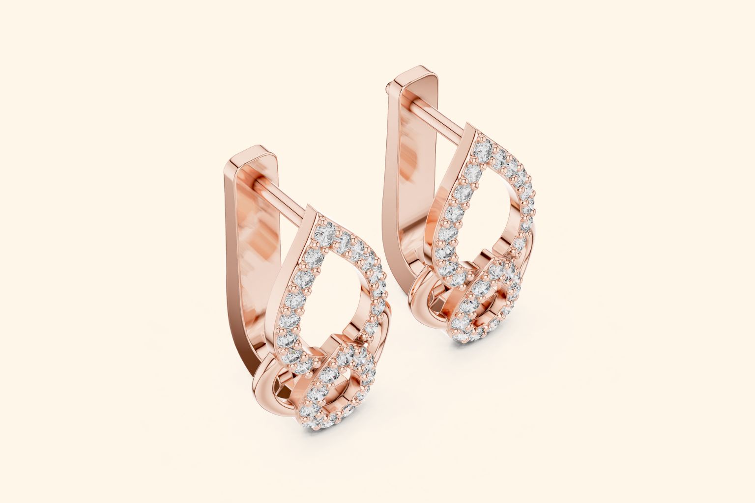 Rose gold hoop earrings with diamond accents on a light beige background