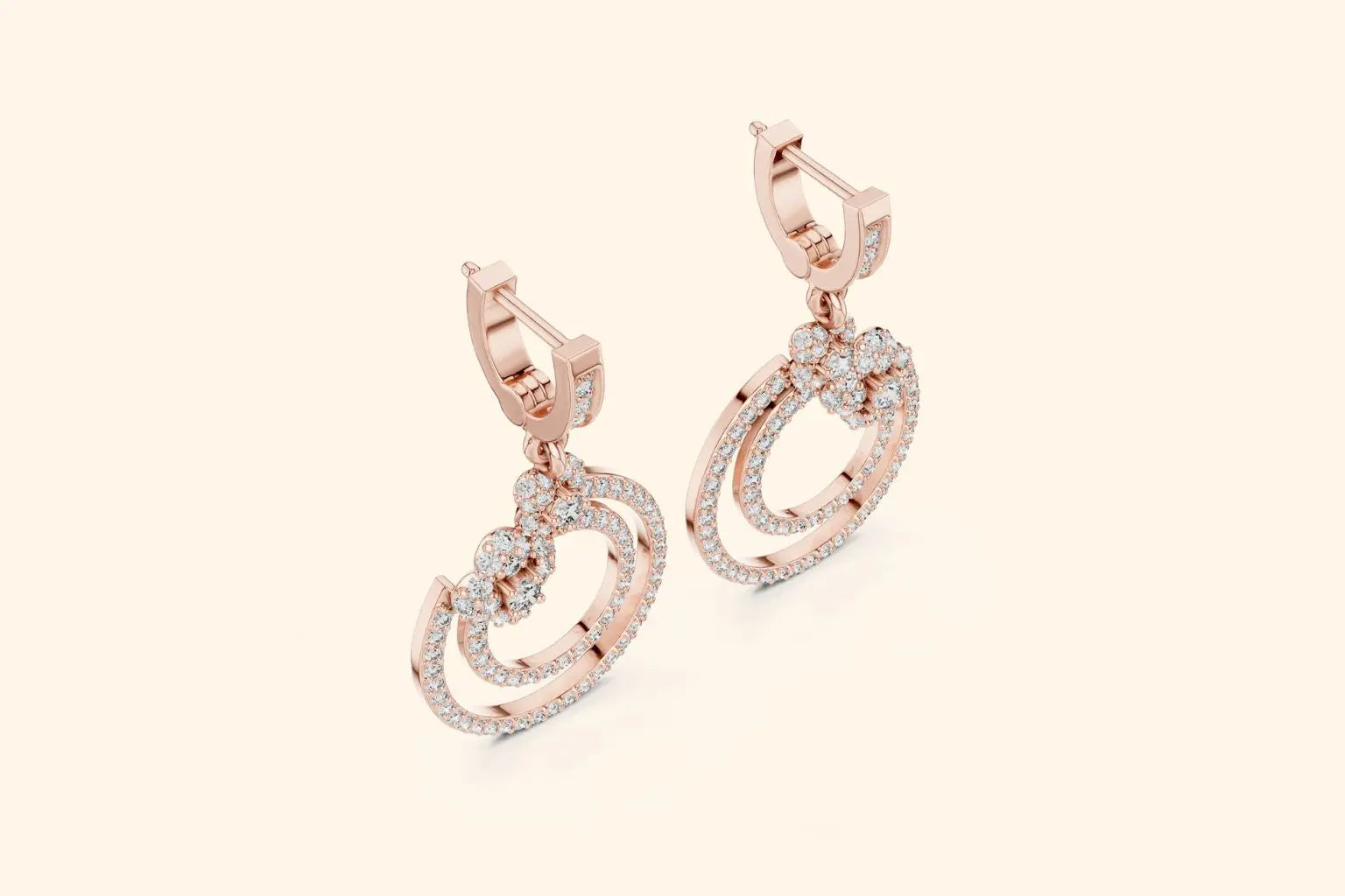 Rose gold earrings with diamond accents on a light pink background