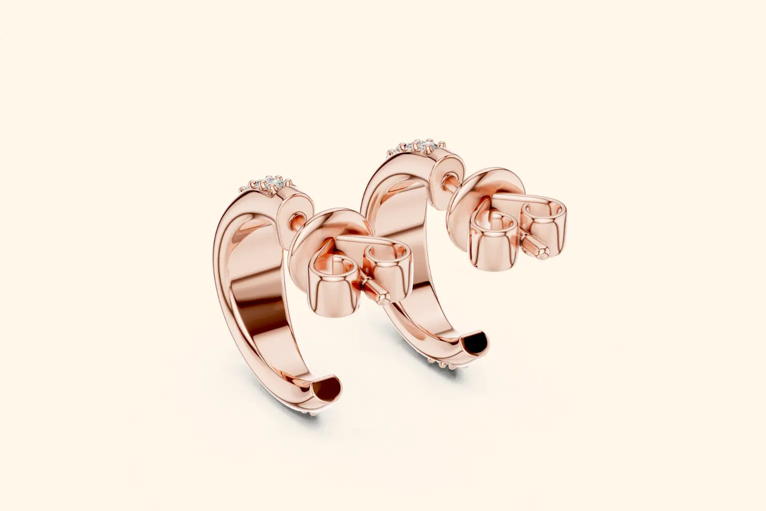 Rose gold hoop earrings on a light beige background