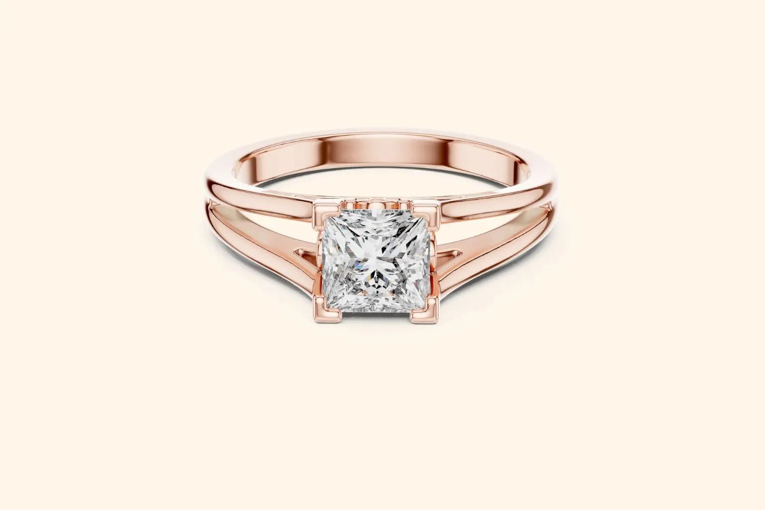 Front view of a rose gold solitaire engagement ring with a radiant-cut diamond set horizontally in a bezel or partial bezel setting, featuring a minimalist split-shank band.