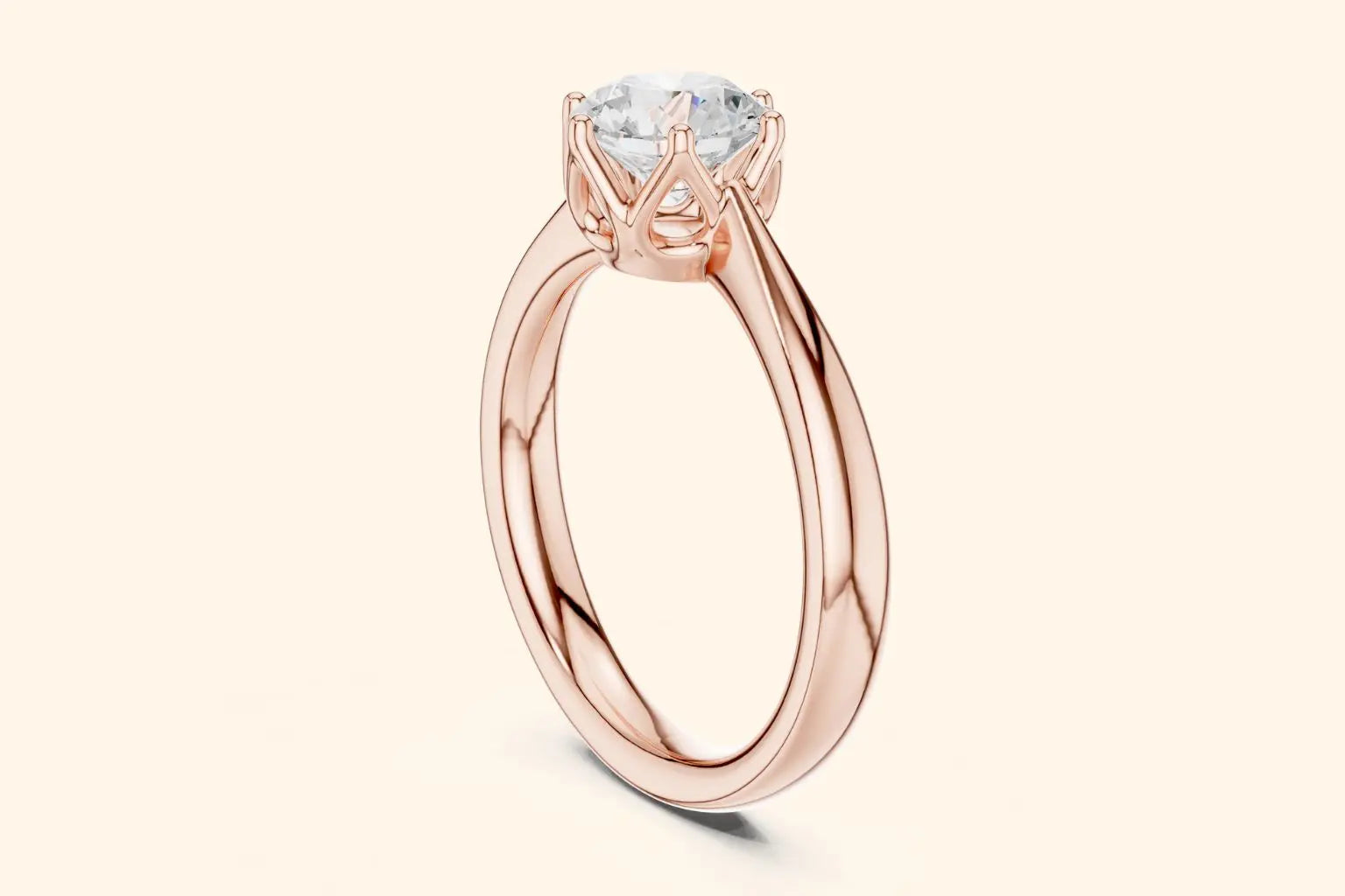 A side view of a simple, polished rose gold ring band flowing up to a high-set, six-prong diamond solitaire setting.