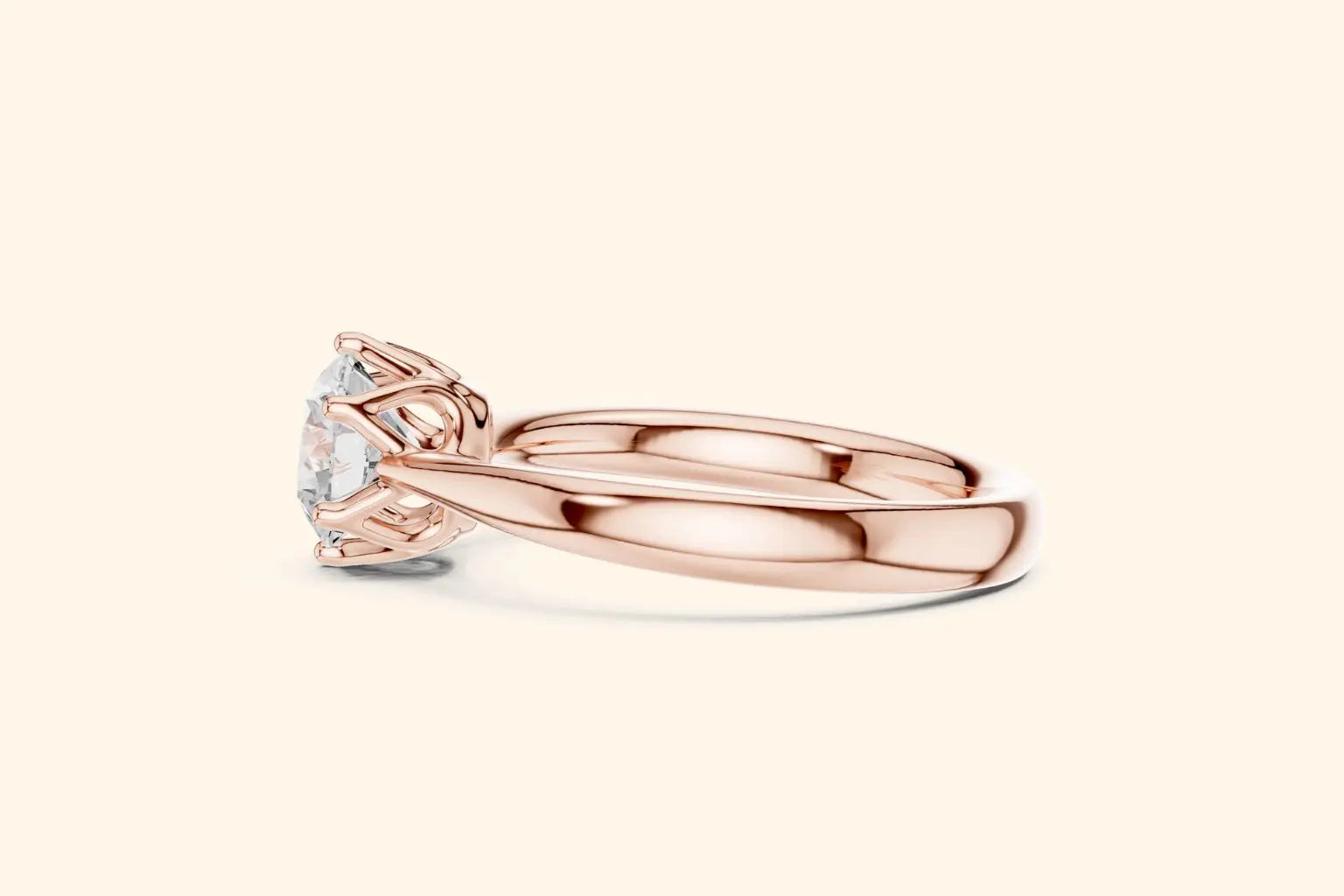 Side profile view of a rose gold engagement ring with a high-set diamond, showcasing the polished band and the intricate, six-prong basket setting.