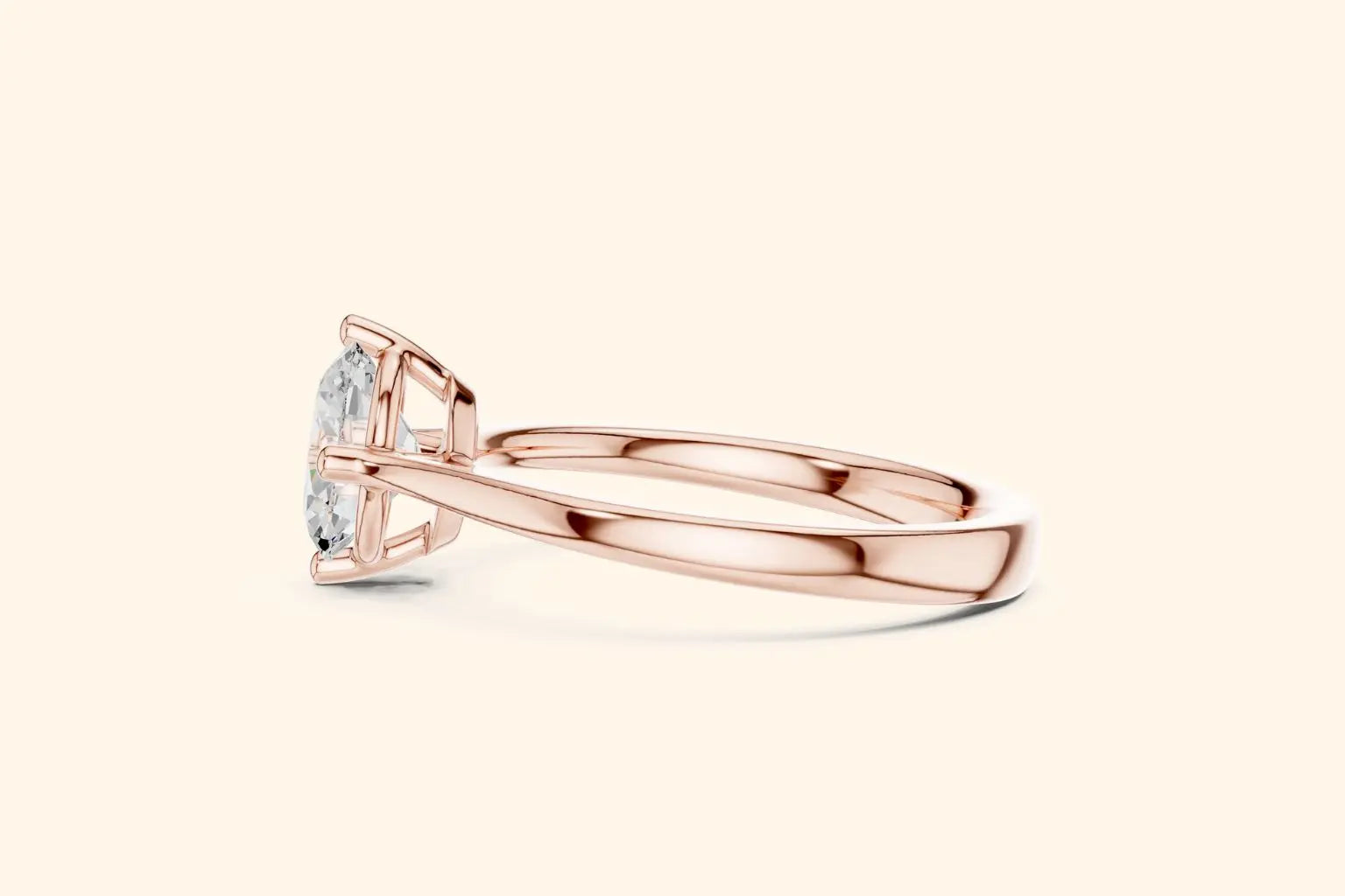 Side profile view of a polished rose gold engagement ring, showcasing the streamlined band and the elegant, low-profile basket setting holding the oval diamond.