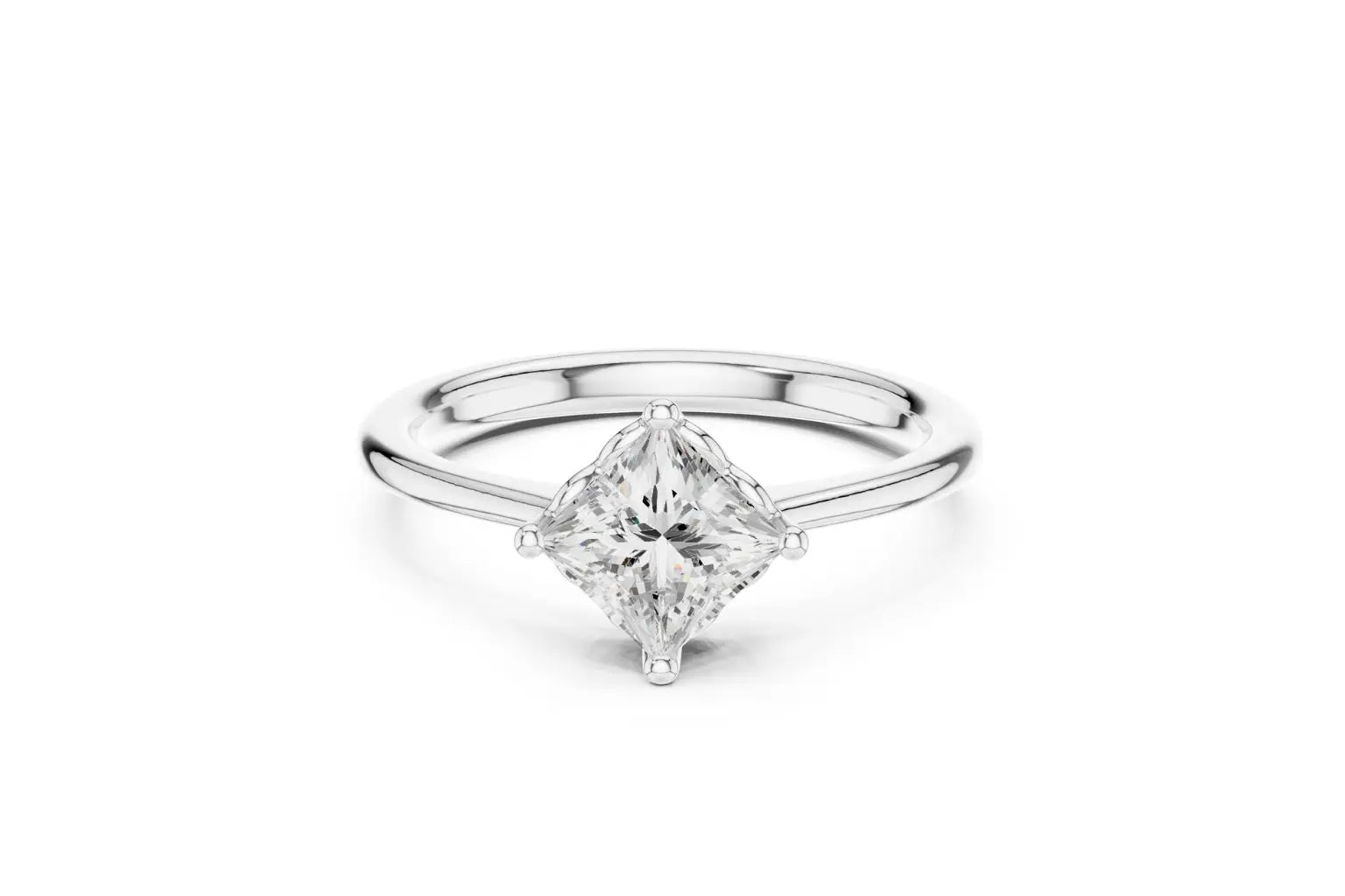 A modern solitaire engagement ring featuring a princess-cut diamond set diagonally in a four-prong setting on a polished white gold or platinum band.