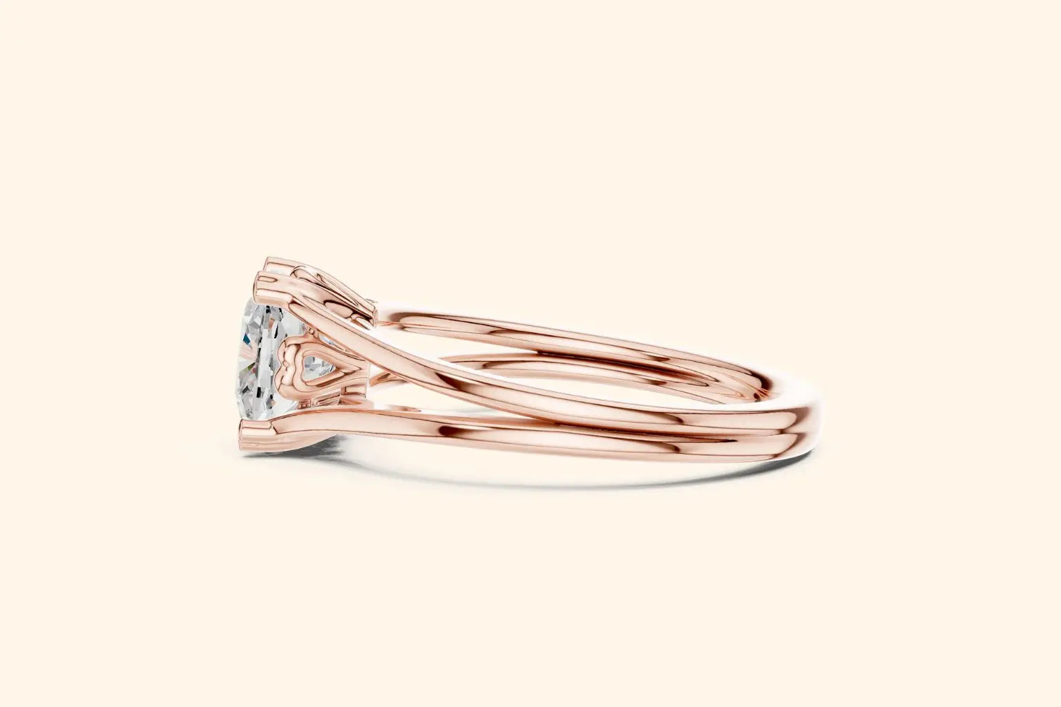 Side profile view of a rose gold engagement ring, showing the low-profile setting, the ornate gallery, and the smooth, split-shank band.