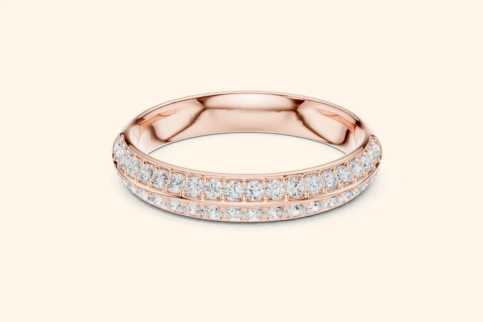 A stunning rose gold eternity band ring with two rows of pave-set round brilliant diamonds spanning the entire circumference. The metal is highly polished, and the diamonds are set closely together with minimal visible prongs. The ring has a slightly rounded profile.