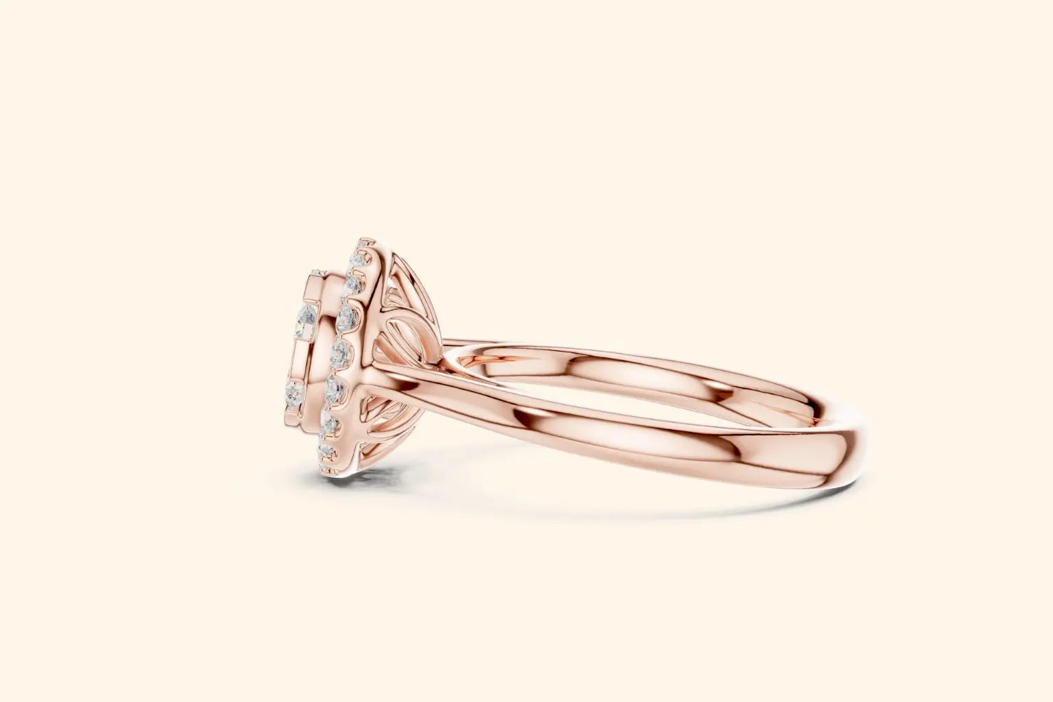 A horizontal, close-up side view of a rose gold ring showcasing the setting's detail. The diamond cluster and halo are clearly visible, supported by an intricate basket setting above the sleek, polished rose gold band.