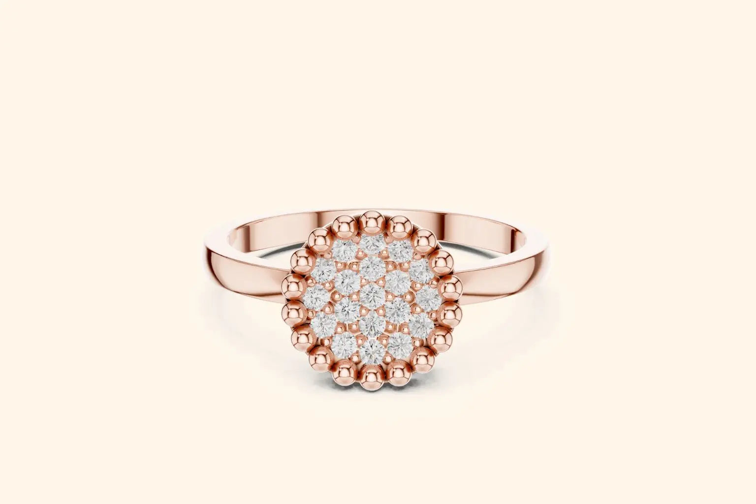 A straight-on view of a modern rose gold ring featuring a round center paved with brilliant diamonds, finished with a bold, beaded or milgrain border on a sleek band.