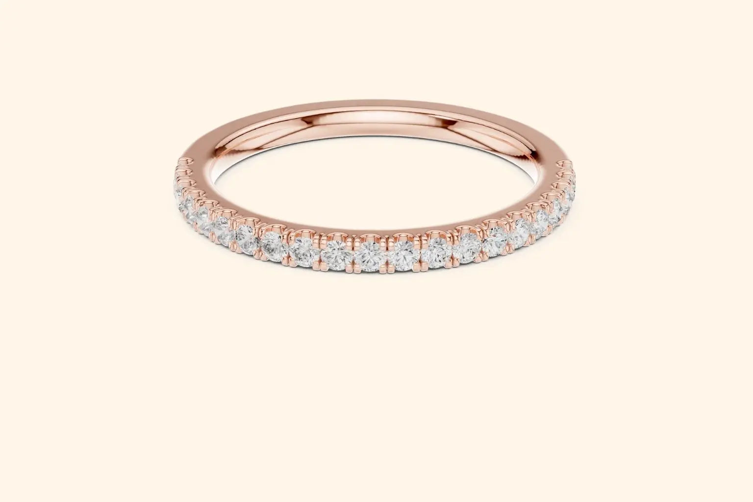 Rose gold ring with round-cut diamonds in a polished, elegant band design. 4