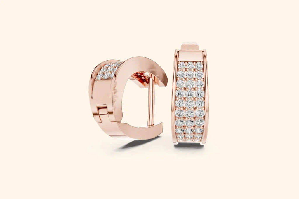 Rose gold hoop earrings with diamond accents on a light beige background