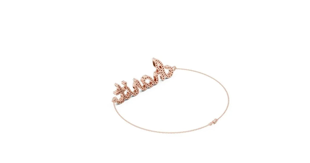 Low-angle view of the back and side of the rose gold script name bracelet, showing the diamond setting details.