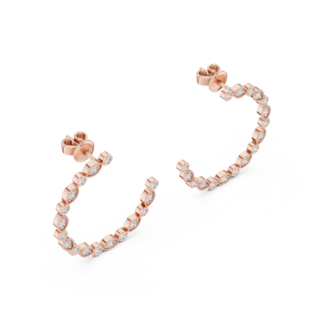 Rose gold hoop earrings with clear gemstones on a white background