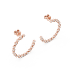 Rose gold hoop earrings with clear gemstones on a white background