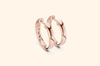 Side profile of rose gold chunky huggie hoop earrings showing the polished metal and inner diamond setting