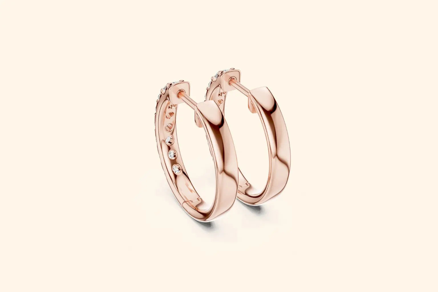 Side profile of rose gold chunky huggie hoop earrings showing the polished metal and inner diamond setting