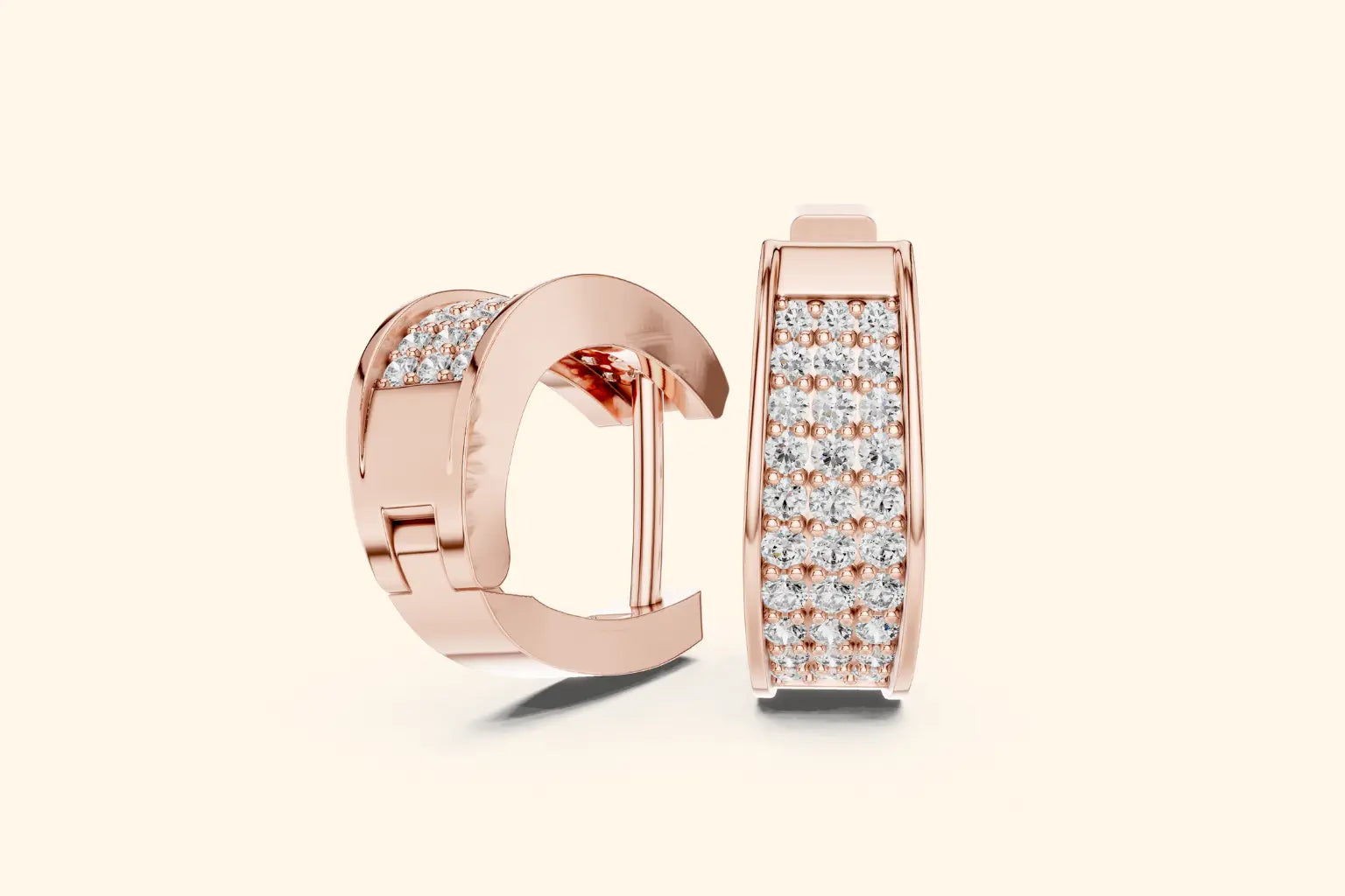 Rose gold hoop earrings with diamond accents on a light beige background