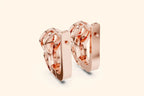 Rear view of rose gold lever-back earrings with an openwork design