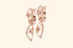 Two rose gold lever-back earrings featuring a central round brilliant diamond in a modern setting.