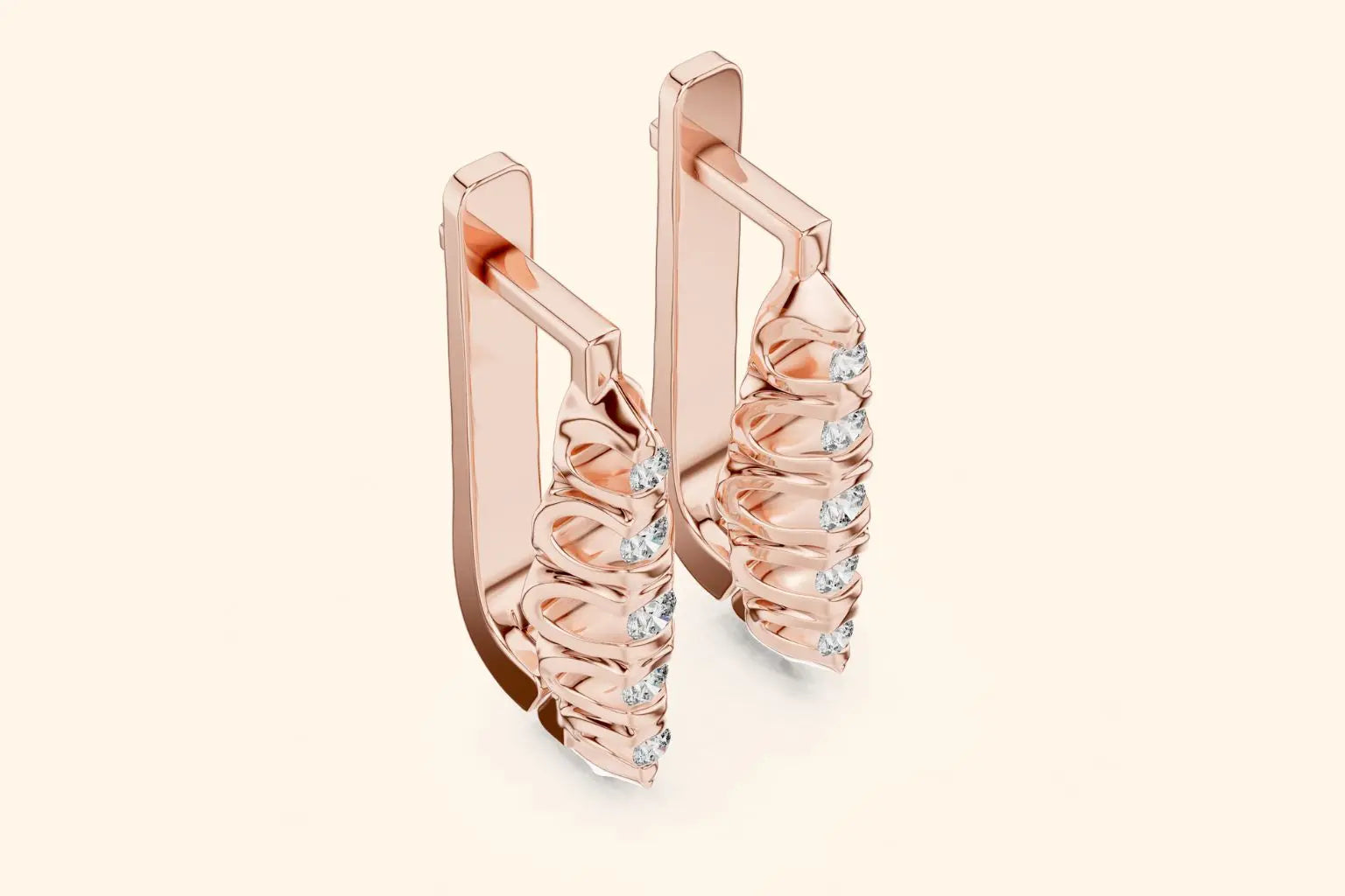 Rose gold hoop earrings with small diamonds on a light beige background