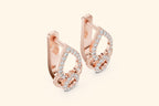Rose gold hoop earrings with diamond accents on a light beige background