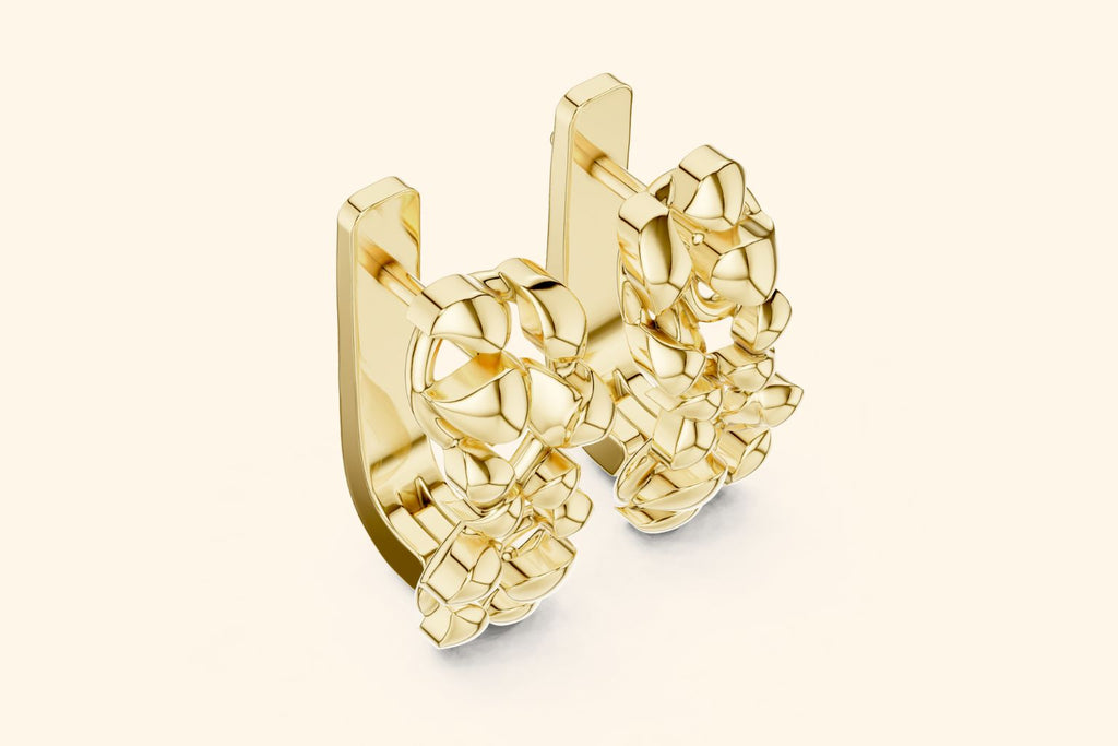 Gold earring on a light beige background