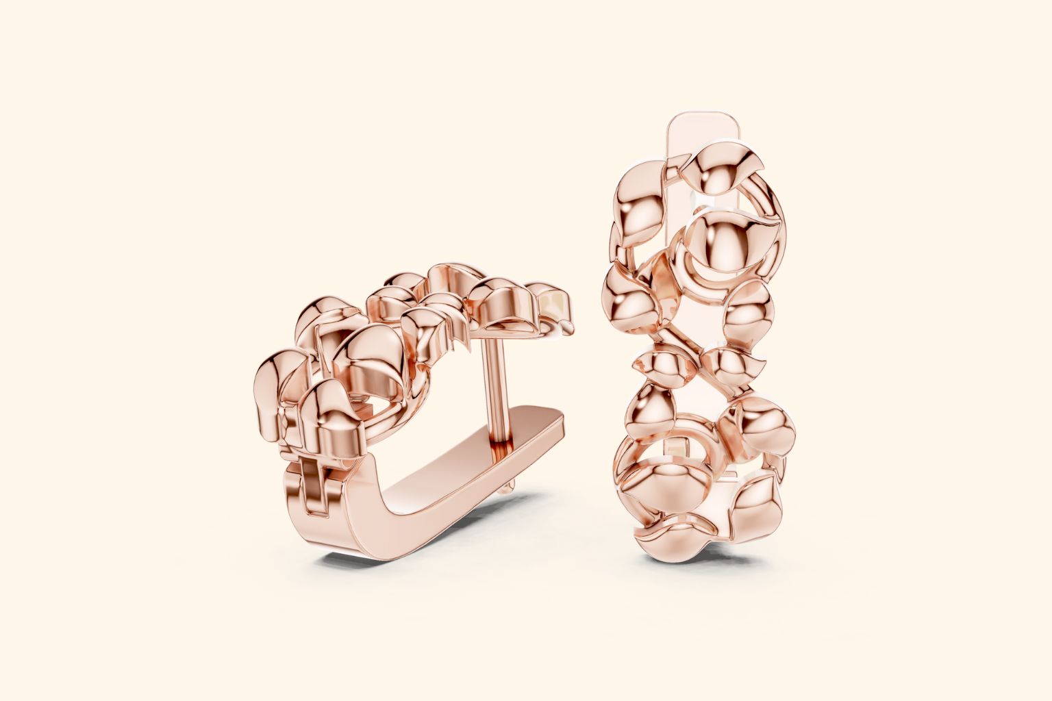 Rose gold hoop earrings on a light beige background