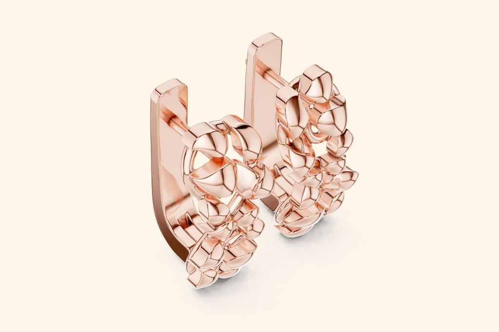 Rose gold earring on a light beige background