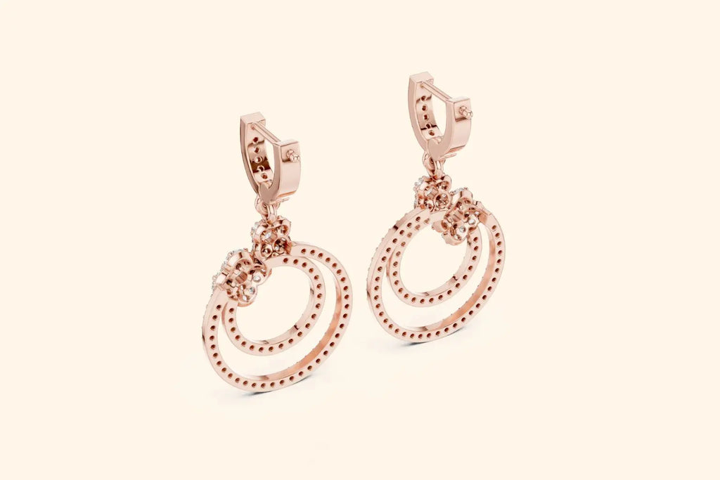 Rose gold hoop earrings on a light beige background