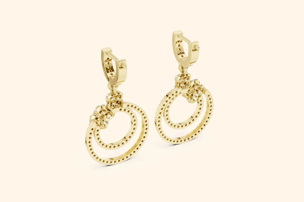 Gold hoop earrings on a beige background