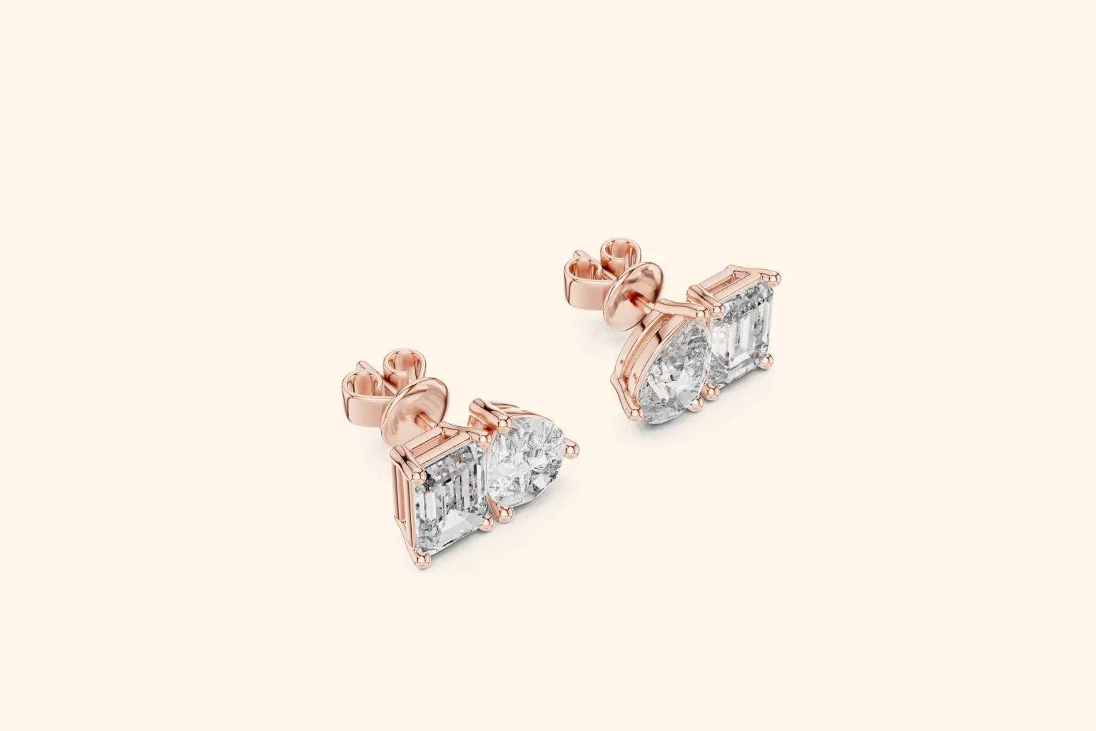 Rose gold earrings with clear gemstones on a light beige background