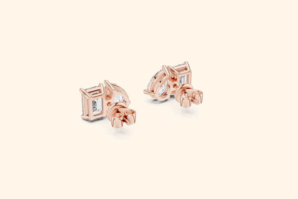 Rose gold earrings with clear gemstones on a light beige background