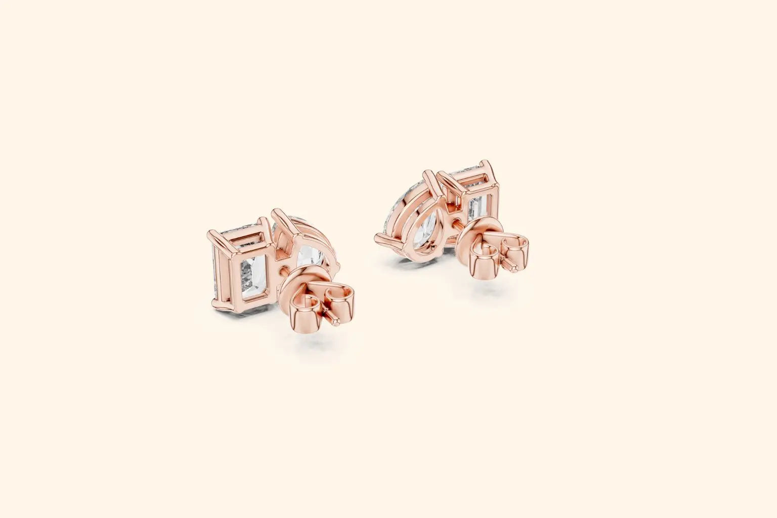 Rose gold earrings with clear gemstones on a light beige background