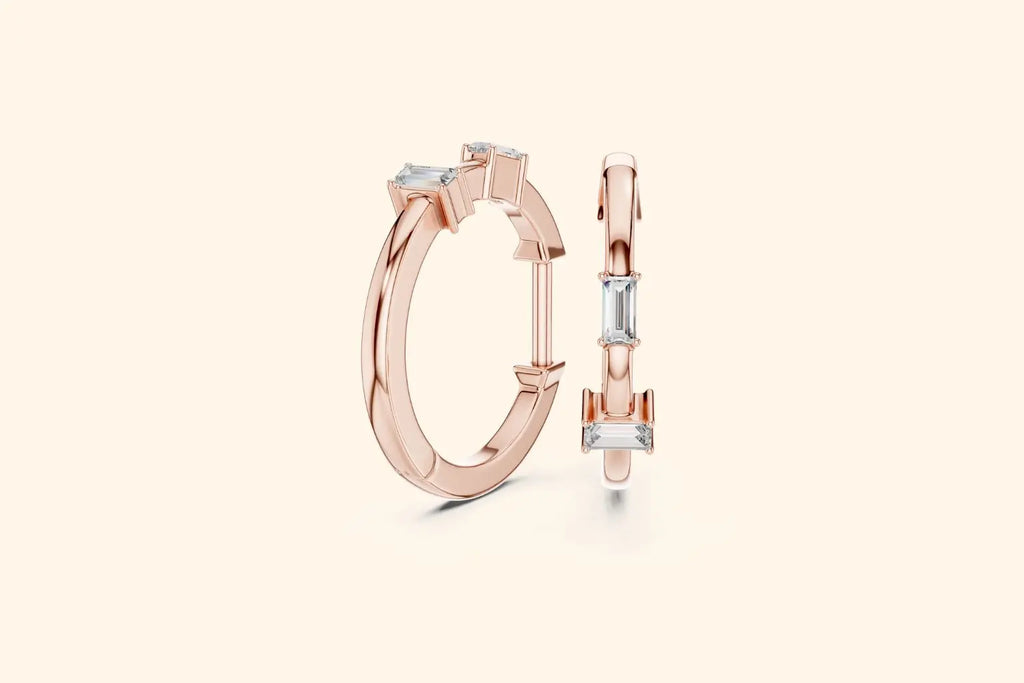 Rose gold hoop earrings with square-cut gemstones on a light beige background