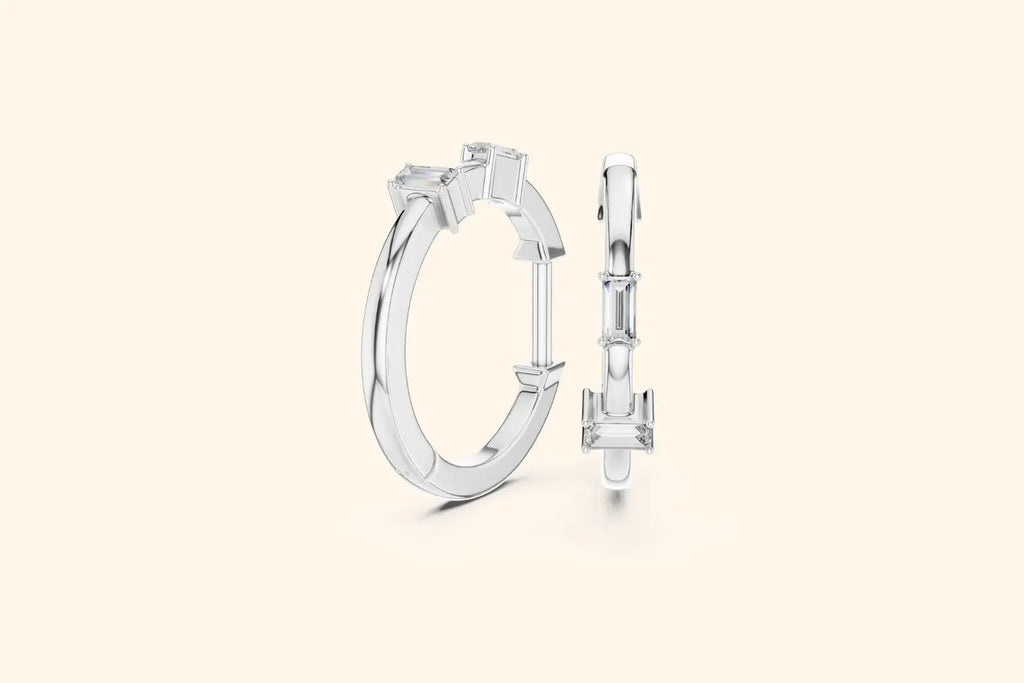 Pair of silver hoop earrings on a light beige background