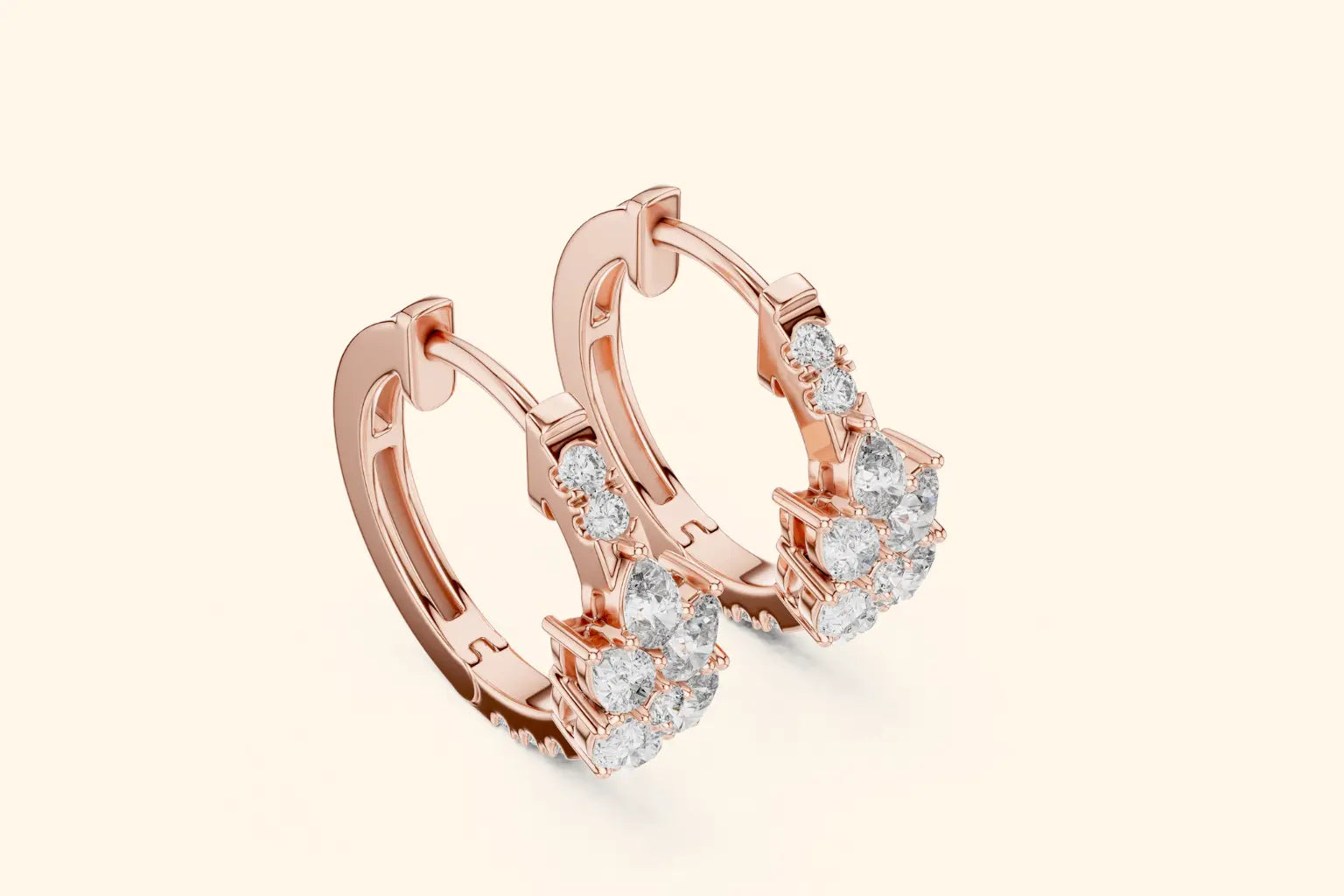 Rose gold hoop earrings with clear gemstones on a light beige background