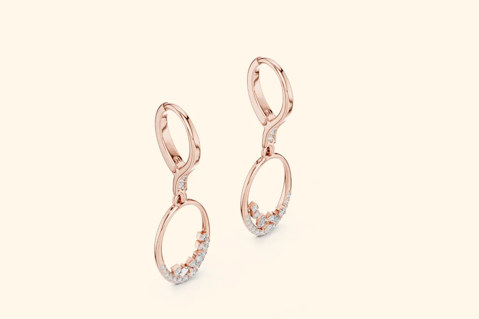 Rose gold earrings with small diamonds on a light beige background