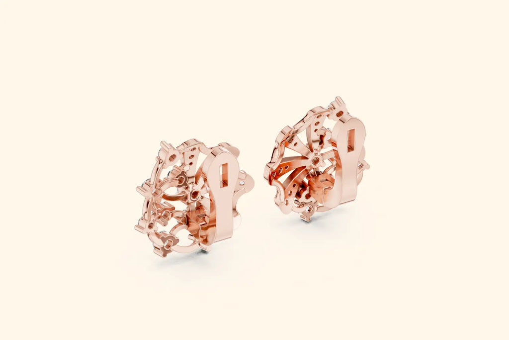 Rose gold earrings on a light beige background