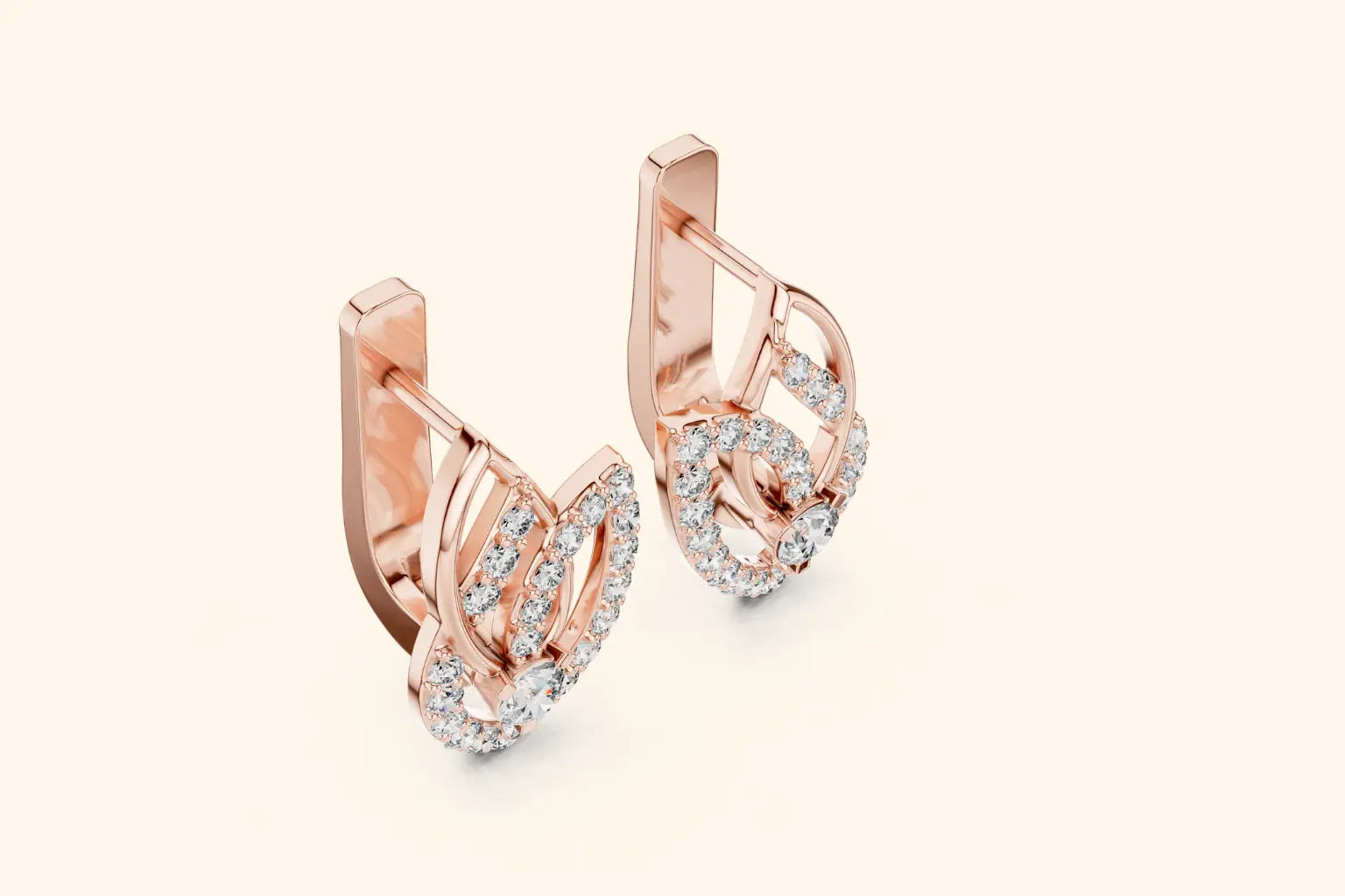 Rose gold earrings with diamond accents on a light beige background