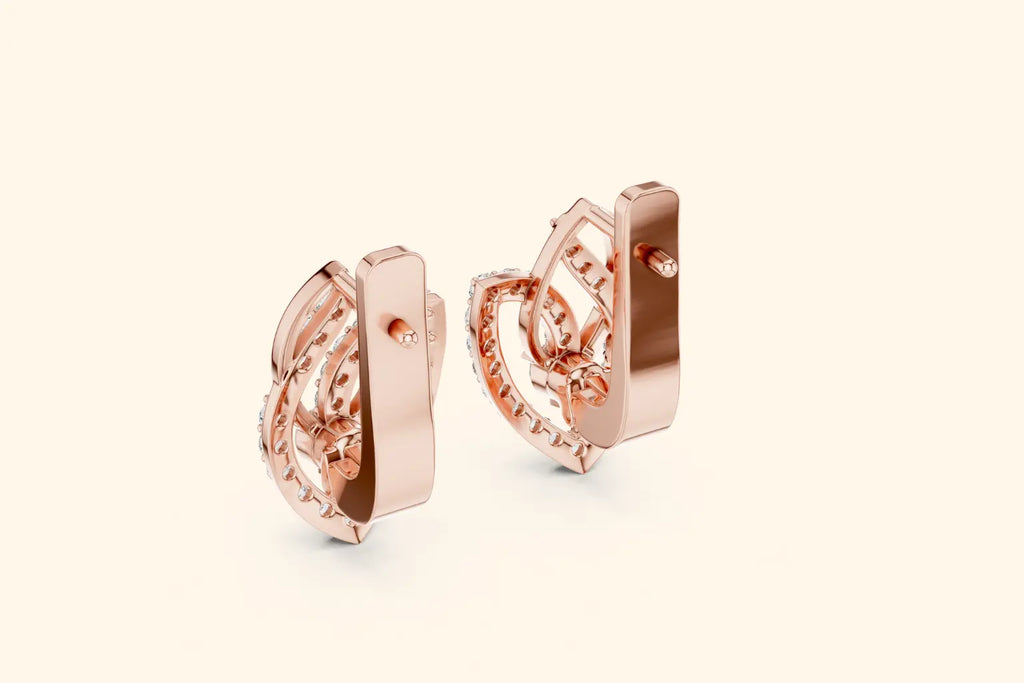 Rose gold earrings on a light beige background