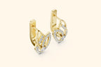 Gold earrings with diamond accents on a beige background