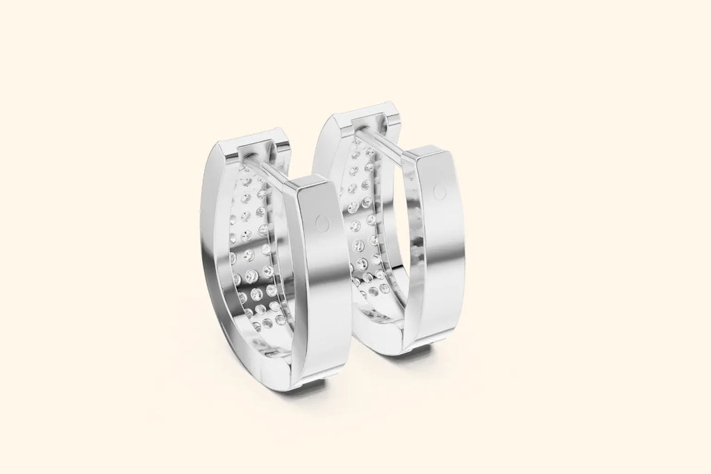 Pair of silver hoop earrings on a light beige background