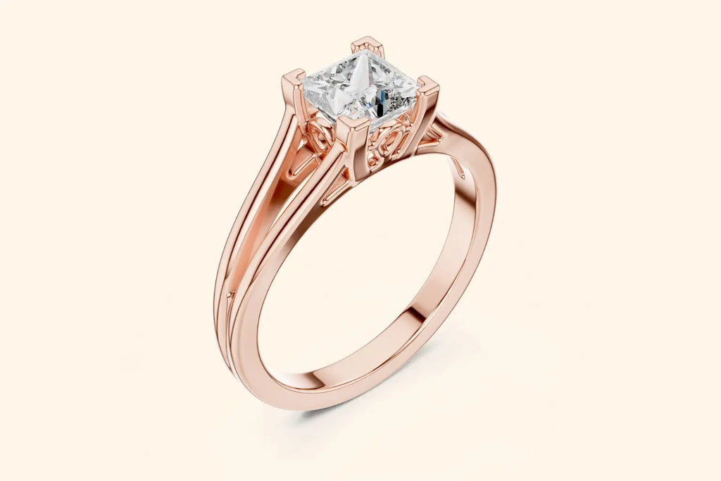 Front view of a rose gold solitaire engagement ring featuring a square brilliant-cut (Princess or Cushion) diamond set in a four-prong setting with decorative filigree details under the basket and a split-shank band.
