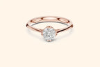 Front view of a rose gold solitaire ring featuring an oval or marquise-cut diamond set horizontally in a four-prong basket on a smooth, wide, rounded band.