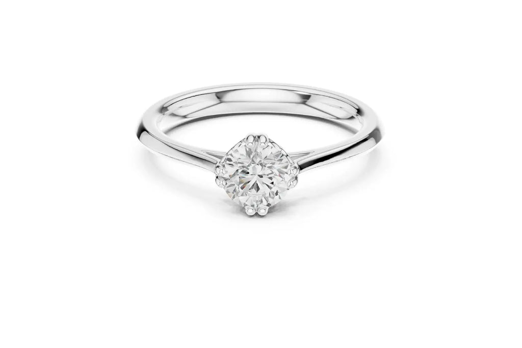 Front view of a silver-colored metal solitaire ring featuring an oval or marquise-cut diamond set horizontally in a four-prong basket on a smooth, wide, rounded band.