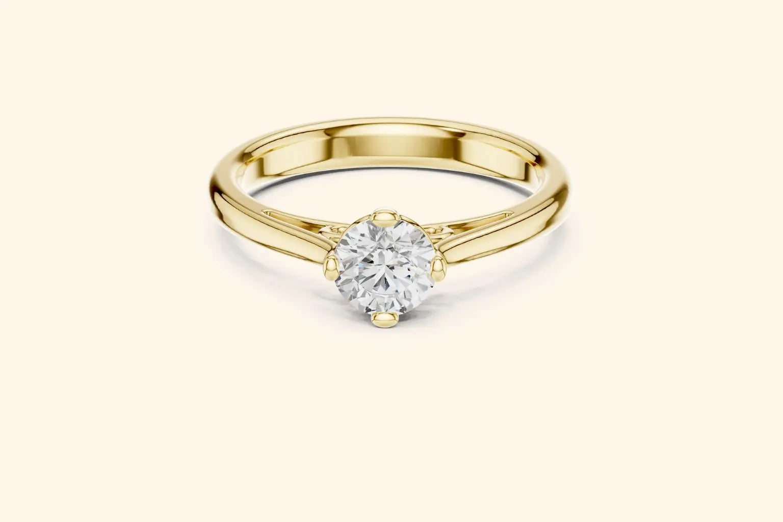 Front view of a yellow gold solitaire ring featuring an oval or marquise-cut diamond set horizontally in a four-prong basket on a smooth, wide, rounded band.
