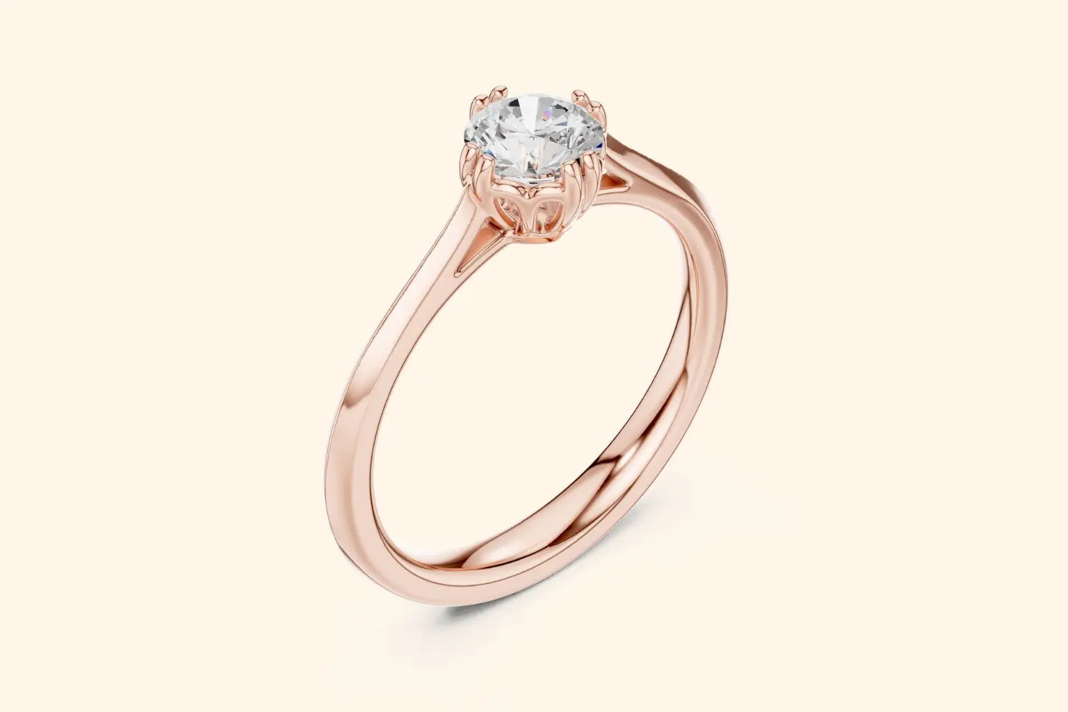 Side view of a rose gold solitaire ring featuring a round brilliant-cut diamond set in a four-prong setting with decorative filigree details under the basket, sitting atop a thin, sleek band.