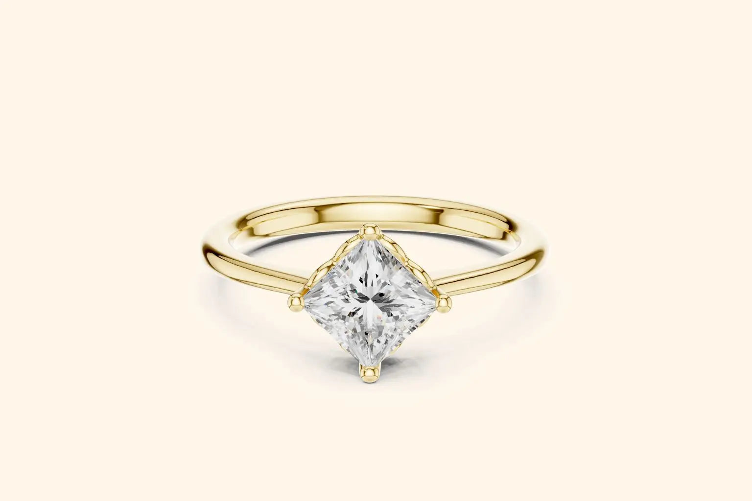 A modern solitaire engagement ring featuring a princess-cut diamond set diagonally in a four-prong setting on a polished yellow gold band.