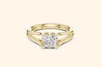 A modern solitaire ring featuring a rectangular diamond set on a wide, elegant split-shank band in polished yellow gold.