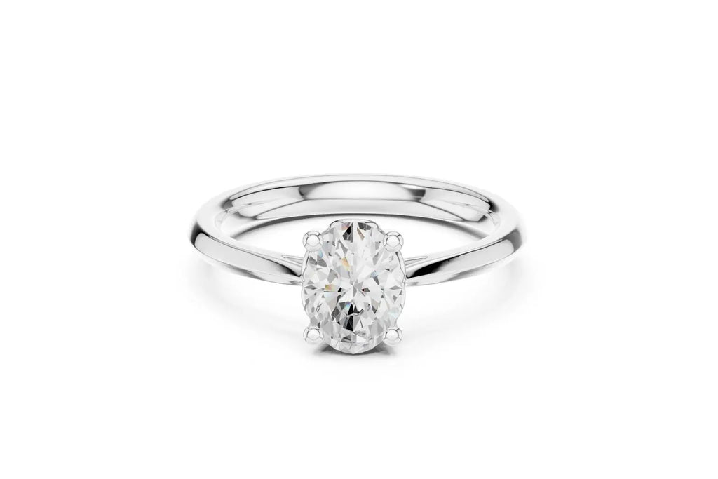 A classic solitaire engagement ring featuring an oval-cut diamond held by six prongs on a polished white gold or platinum band.